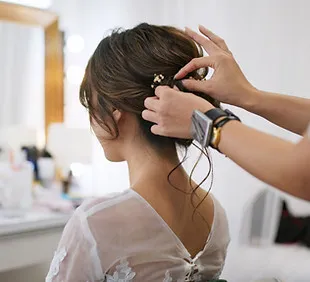 Hairdresser styling a client in a salon